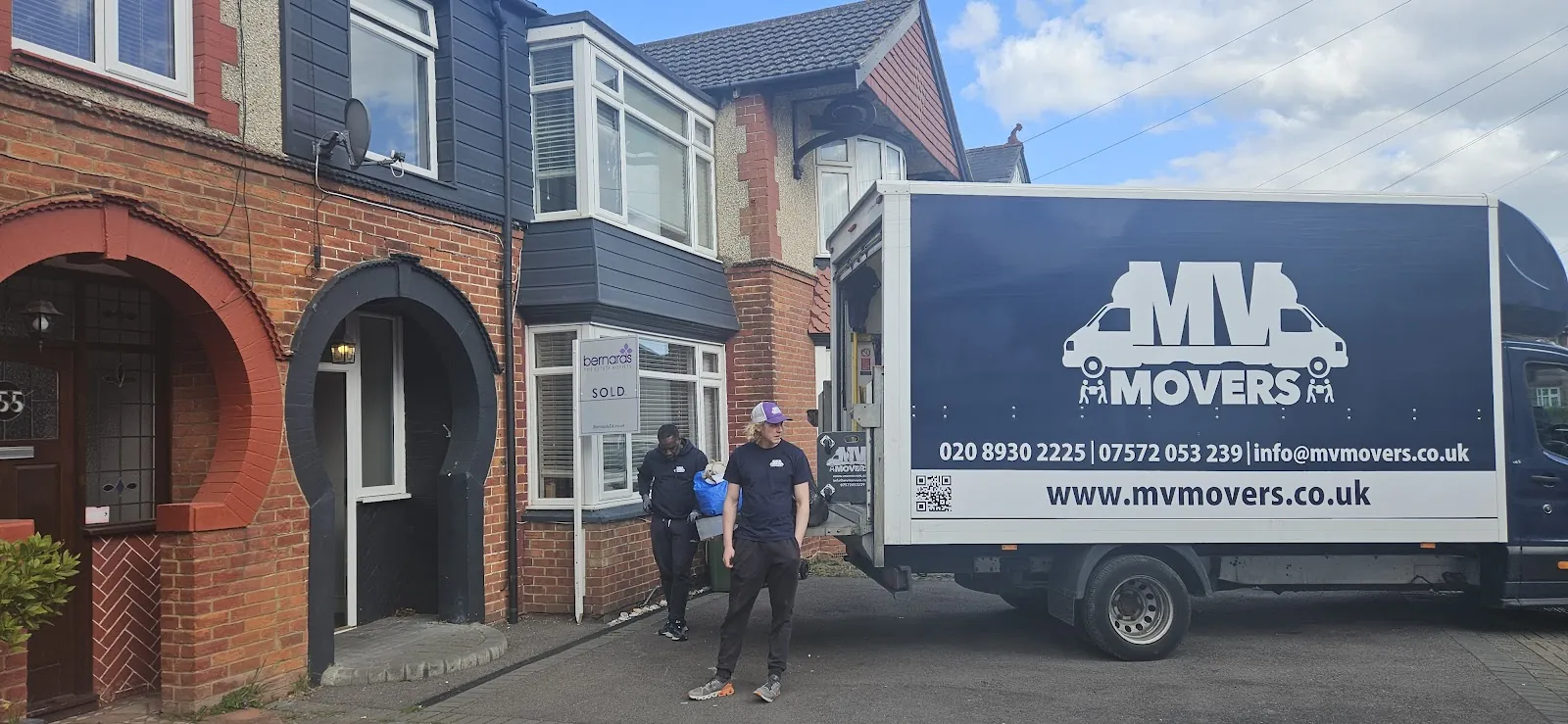 MV Movers van and crew outside a Victorian house on a West London removal MV Movers van and crew outside a Victorian house on a West London removal