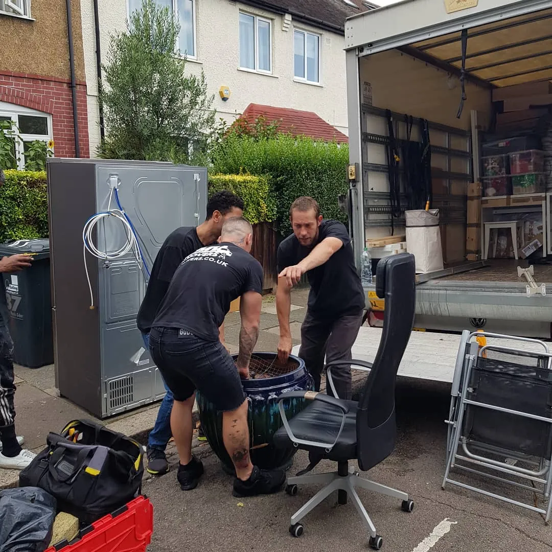 MV Movers crew loading office chairs and a fridge onto the van – Office Relocations West London