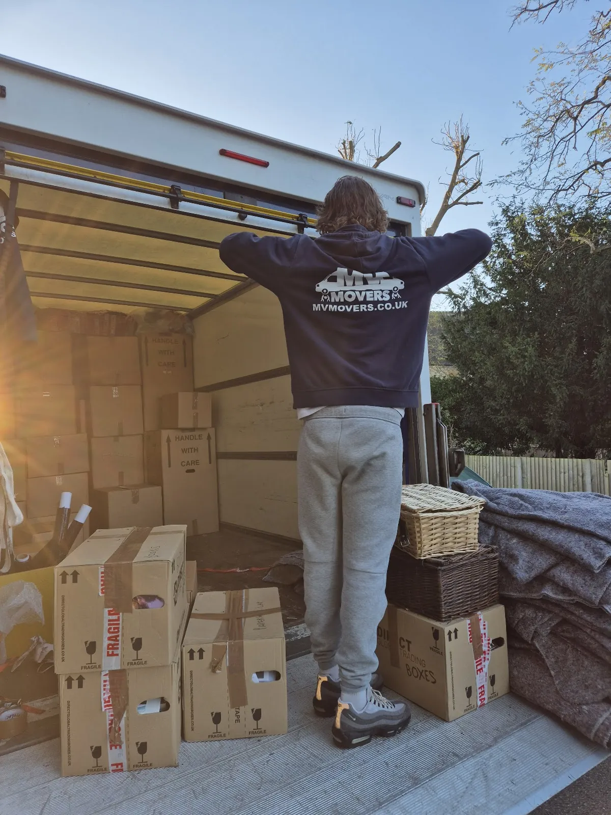 MV Movers crew member with packed boxes stacked ready for the van – Packing Service West London